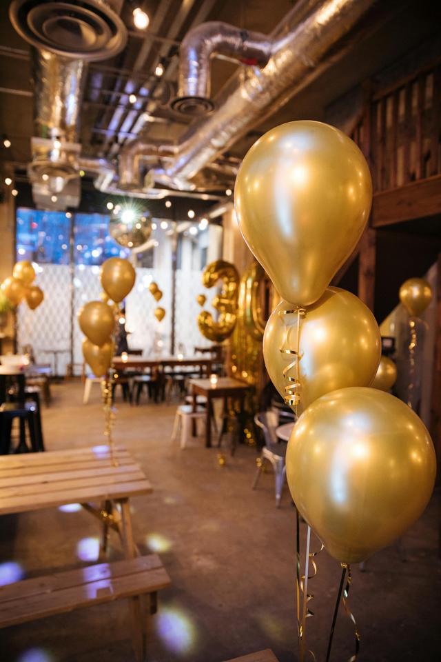 Golden baloons inside the Lockdown Room party area with a 30th birthday baloon showing in the background